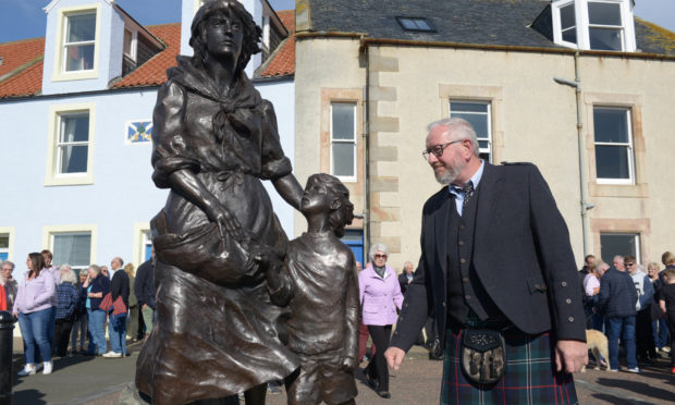 Sculptor Alan Herriot admires the memorial.