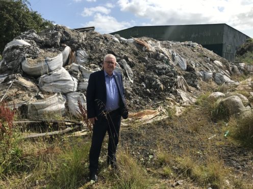 Douglas Chapman beside the rubbish at Lathalmond.