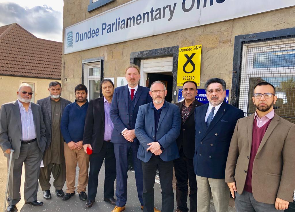 Mr Law and Mr Hosie with members of the Dura Street Mosque.