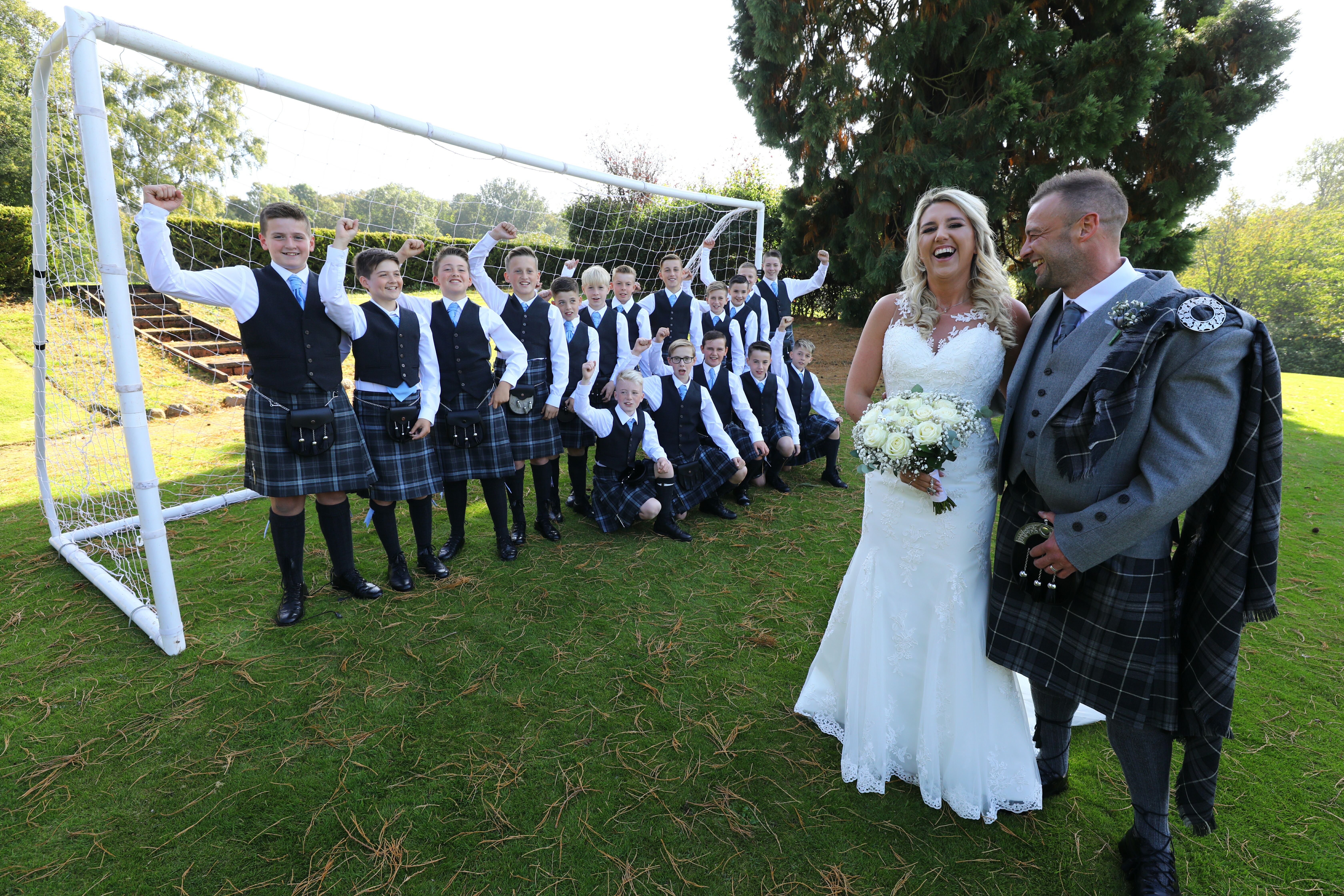 Callum and Danielle on their wedding day with the Fair City FC under-13s squad