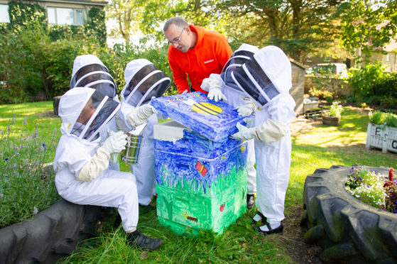 Dairsie primary pupils with their bee hive. 
L to R - Louis Wainwright, Sophie Reid, May Hain, Meik Molitor of Webster Honey, Elliot Lawrence and Jennifer Rodriguez.