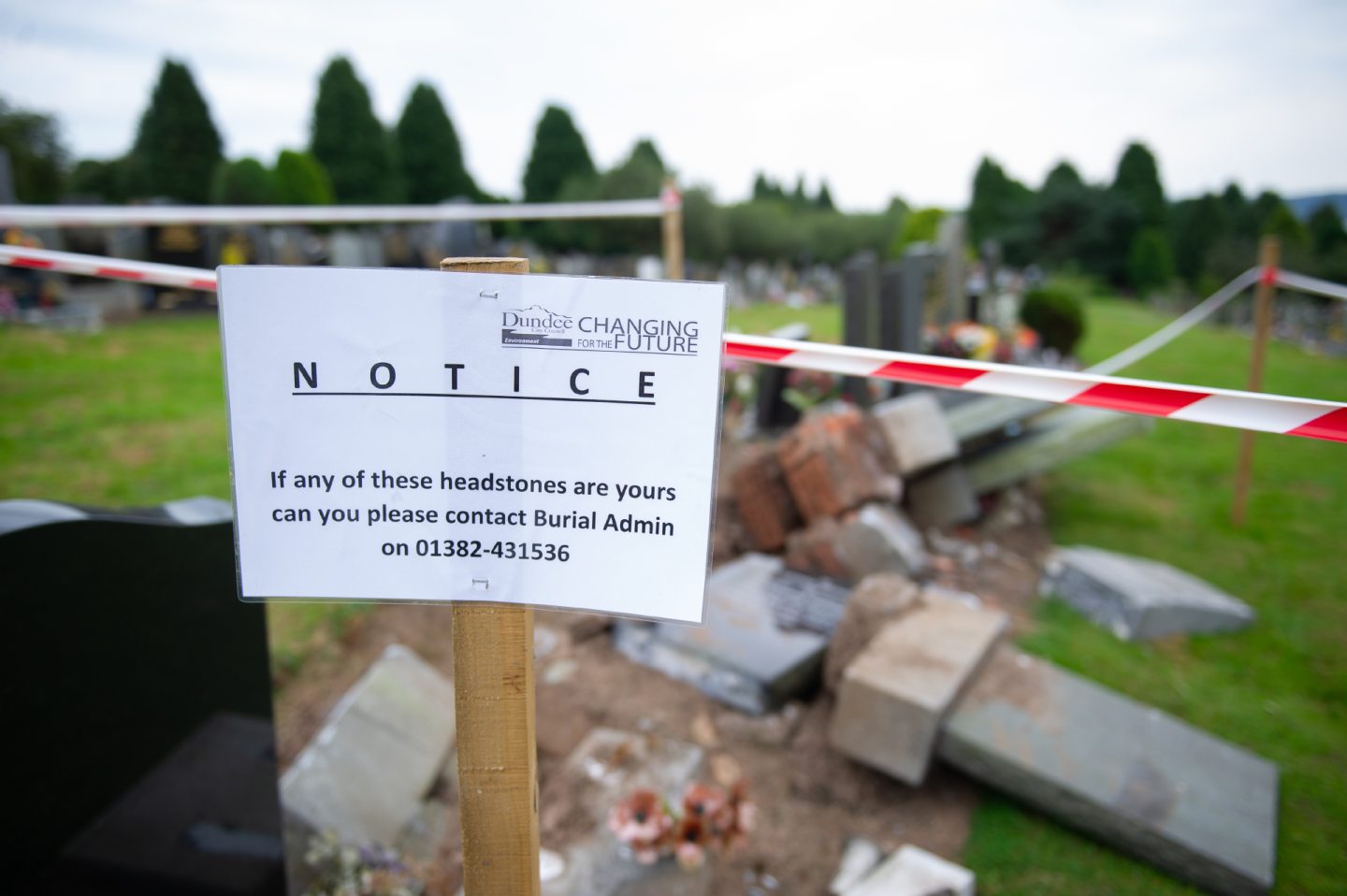 The council advisory notice left at the damaged headstones at Balgay Cemetery in August.