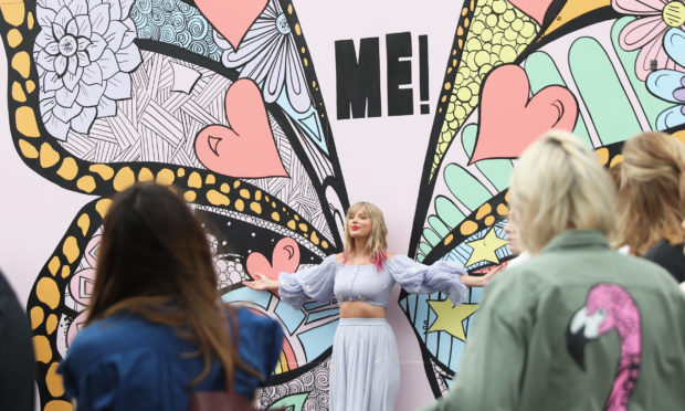 Taylor Swift poses with one of Kelsey Montague's creations.