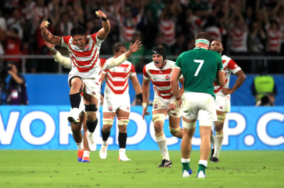 Japan's players celebrate their victory over Ireland.