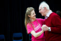 A dance tutor with a participant.