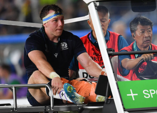 Scotland's Hamish Watson is driven off injured during Sunday's game.