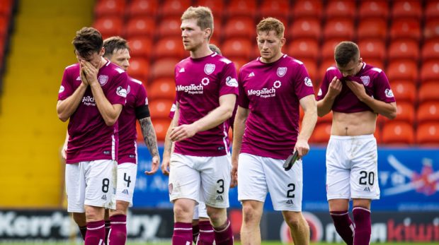 The Arbroath players look dejected at full-time at Tannadice.