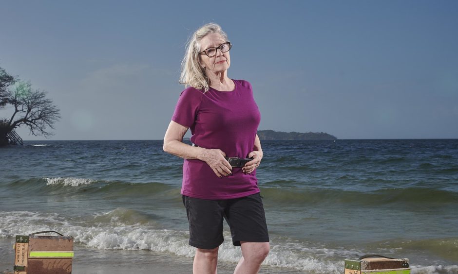 Irene Cattanach posing against desert island backdrop