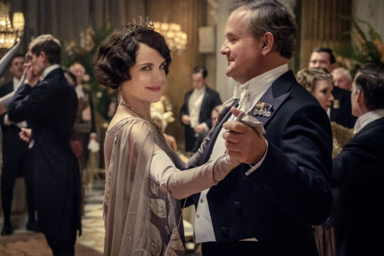 This image released by Focus Features shows Elizabeth McGovern, left, as Lady Grantham and Hugh Bonneville, as Lord Grantham, in "Downton Abbey". The highly-anticipated film continuation of the ÒMasterpieceÓ series that wowed audiences for six seasons, will be released Sept. 13, 2019, in the United Kingdom and on Sept. 20 in the United States. (Jaap Buitendijk/Focus Features via AP)