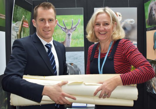 Mr Nicol (L) and Mrs Christie (R) with some of the gifted maps.