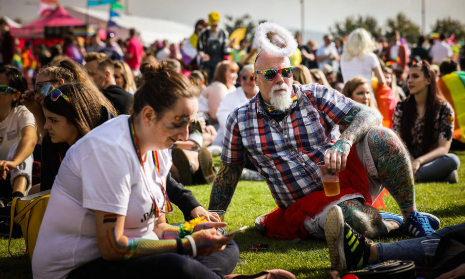 People sitting on the grass at a previous Dundee Pride event