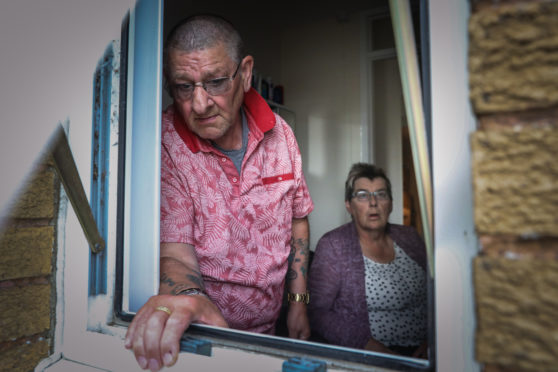 Alister Gillon and Eunice McIntosh beside the bathroom window where the thieves broke in.