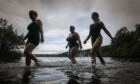 Gayle, right, enters the chilly waters of Clunie Loch with Kelly McIntyre and Mel Chadd.