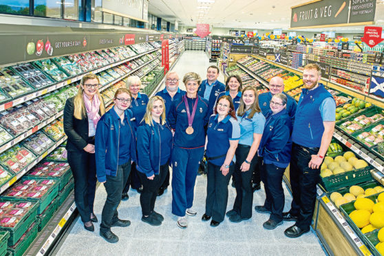 Olympic bronze medallist Sally Walton with area manager Carolin Bartmann, left, Robert Gray, right, and Aldi staff.