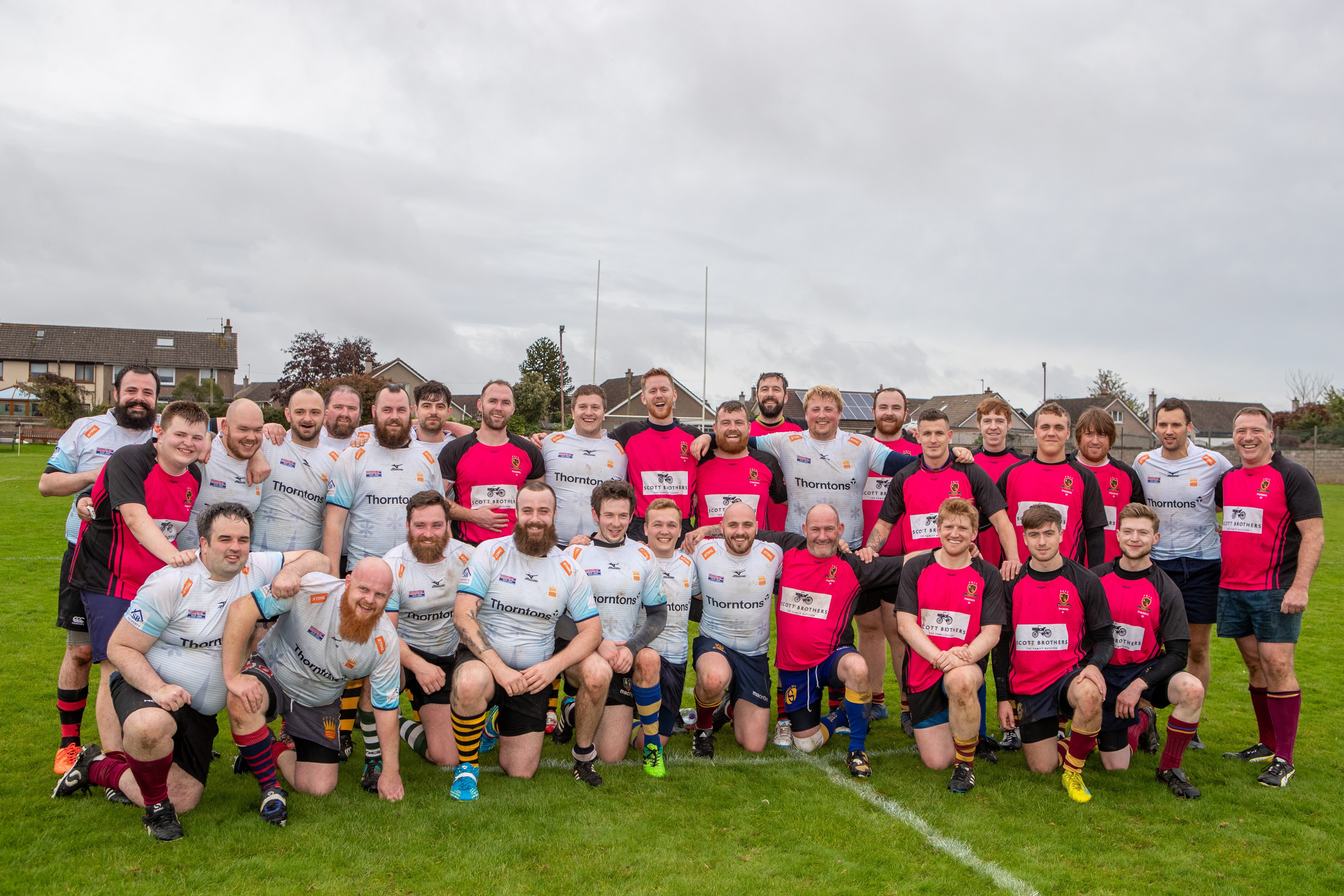 Both teams pose for a photo following Saturday's match.