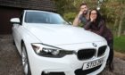 Ewan Fraser and his partner Sharon Shand with their BMW.