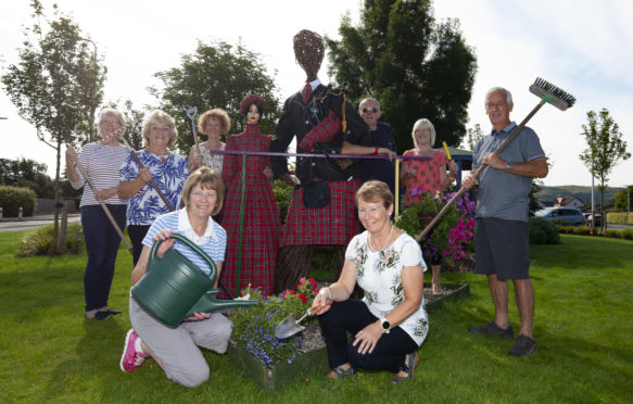 The Brig of Bloom committee show off Tartan figures Flora and Hamish ahead of judging in the summer.