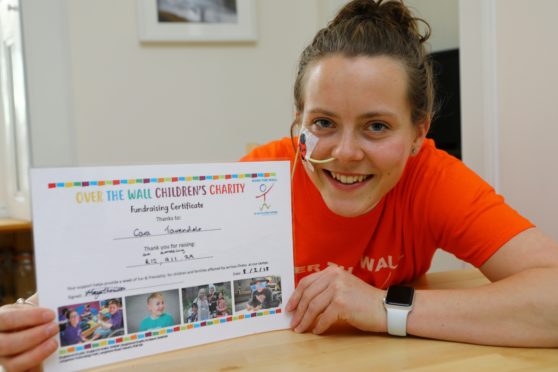 Cara Tavendale with the certificate from Over The Wall for raising over £12,000. Picture credit Dougie Nicolson.