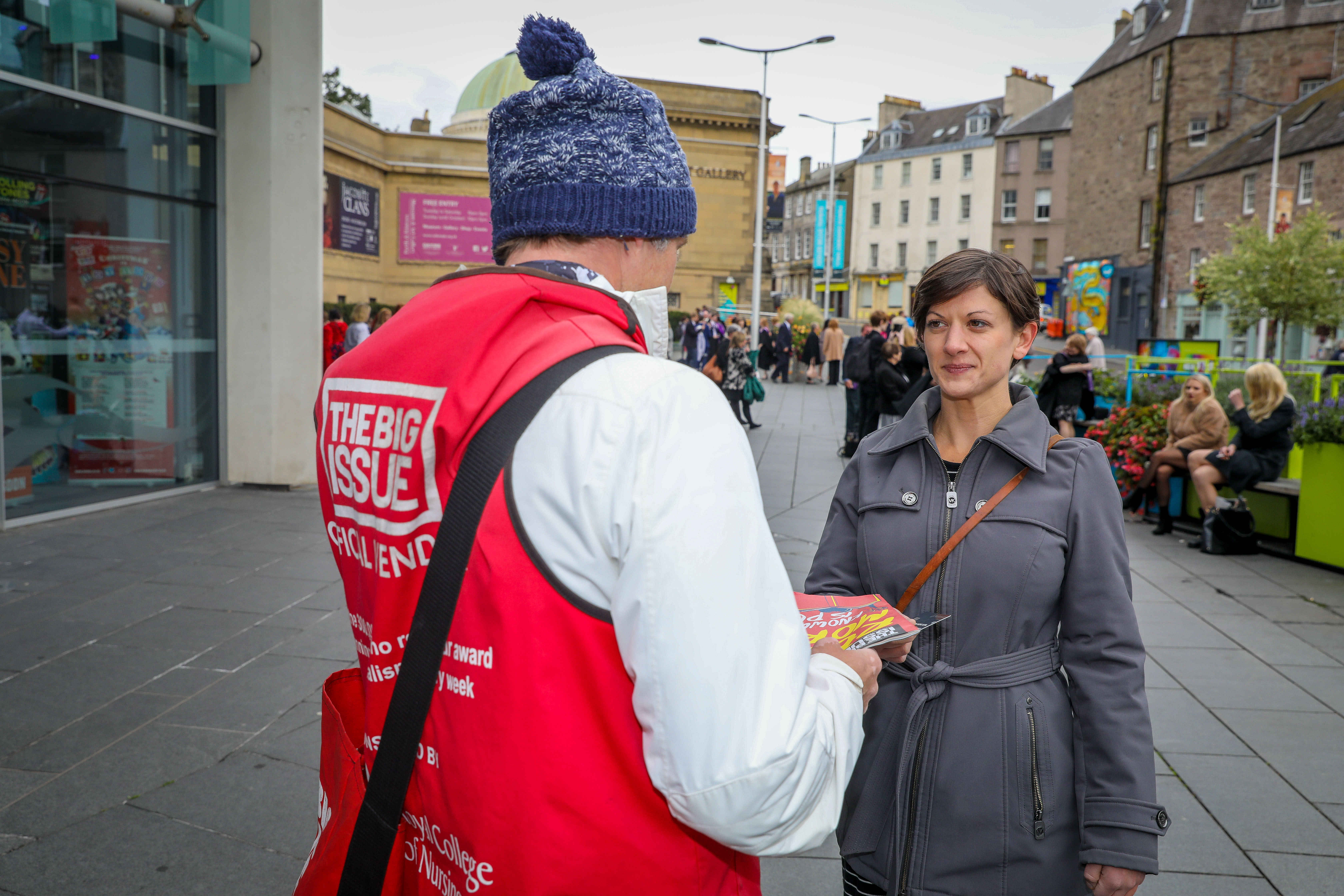 Claire Ferrier looks to purchase a Big Issue from vendor Brian