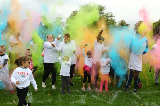 Coloured powder gets thrown at the start of one of the races, at the Colourama Run in Baxter Park, Dundee.