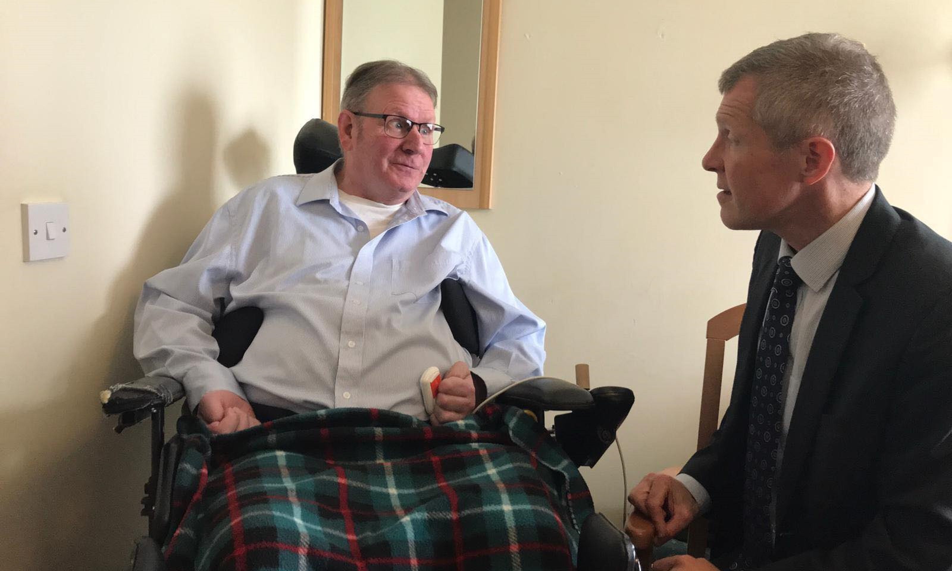 Douglas Dawson tells MSP Willie Rennie how a lack of care package has stranded him in a home for 18 months.