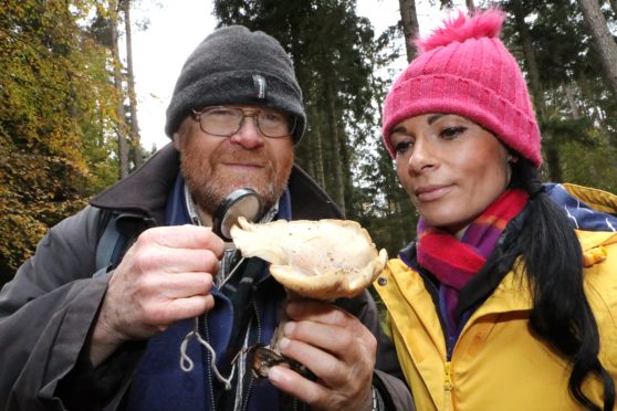 Jim Cook of the Tayside and Fife Fungal Group and Gayle examine a clouded funnel.