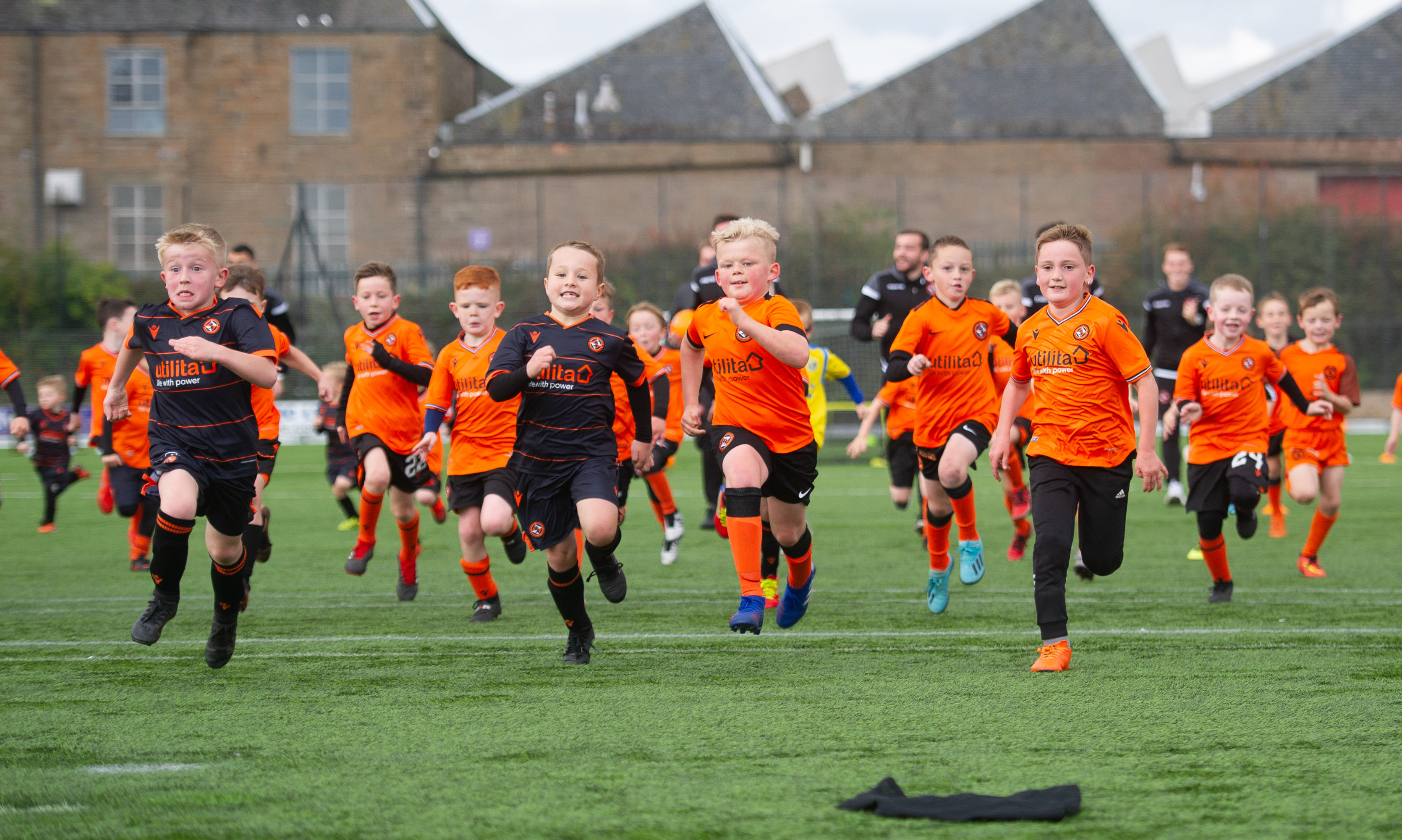 Dundee United players and the children enjoy a run together.