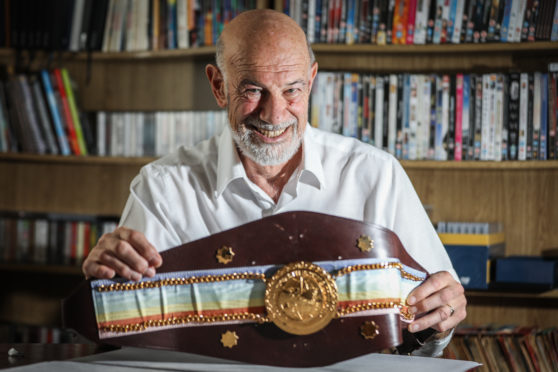 Angus aficionado Eric Armit with a prized Commonwealth Boxing Council title belt.