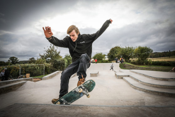 Adam Penman, Tayport Top Park Group chairman, tries out the new skatepark.