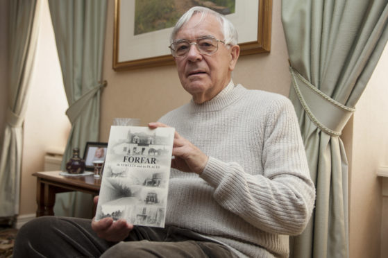 Forfar historian Alex Whyte with one of his books on Forfar streets and places",