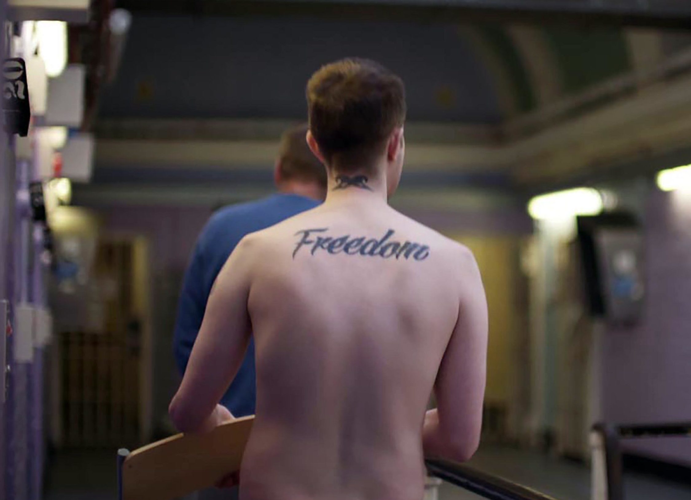 Prisoner with "Freedom" tattoo.