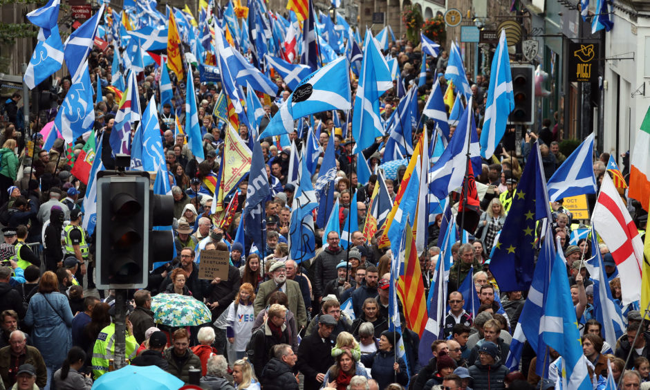 Scottish independence supporters march through Edinburgh during an All Under One Banner march. on Saturday, October 5.