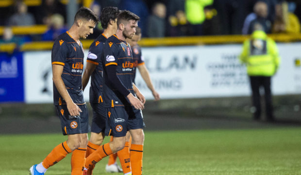 United's players traipse off at full-time.