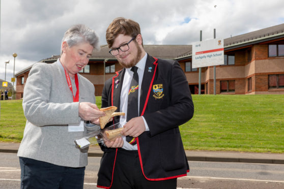 Local councillor Mary Lockhart and pupil Bailey-Lee Robb (17) with one of the sub-standard sandwiches being served.