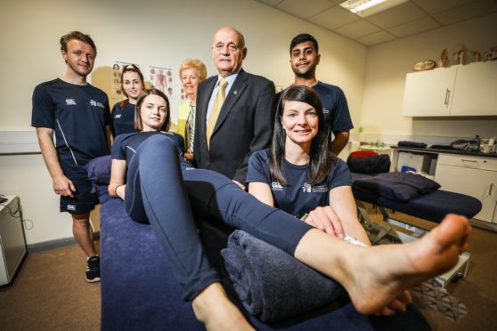 Students with Kenny  and Margaret Simpson at the opening of the sports injury clinic