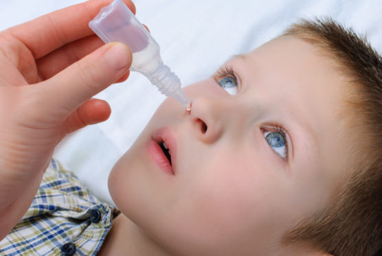 A youngster receiving the nasal flu vaccine.