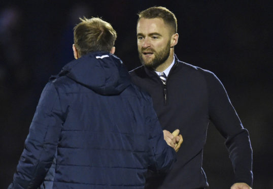 Dundee manager James McPake shakes hands with Paul McGowan at full time.