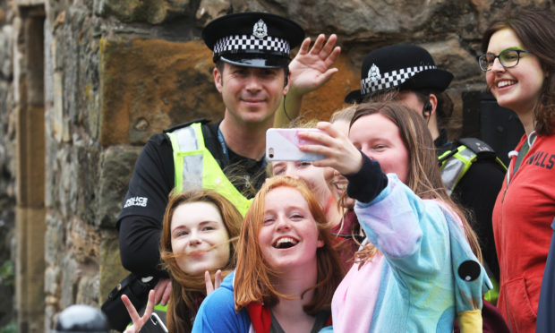 A group of students take a selfie with the police during Raisin Sunday last year.