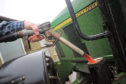 Filling a tractor with red diesel... but reported issues include poor performance, blocked filters and injector failure.