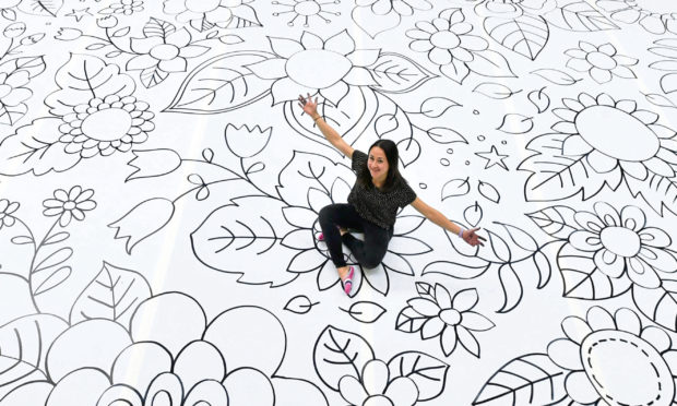 Bestselling illustrator Johanna Basford OBE with the mammoth floral artwork.