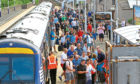 Passengers disembarking at Carnoustie Station for the final round of the Open Golf Championship in 2018.