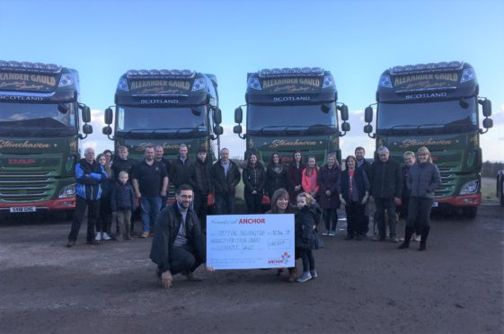 Pictured is Graeme’s wife Laura, their daughter Isla and Graeme’s brother Roy Gauld with staff of Alexander Gauld and Graeme’s family, including his brother Martin and parents.