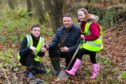 Ralf Coutts of the "St Vigeans Conservation Network" gets some help from Nathan McCormack and Norijane Forbes (both 11) from Warddykes primary school, to plant some young trees in part of the Millenium Forrest at St Vigeans.