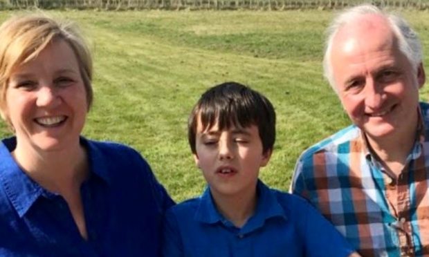 Dylan, 12, with parents Jane and Colin Carmichael