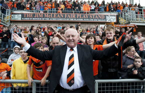 Dundee United legend Jim McLean celebrates with fans after a stand at Tannadice is named after him in 2011.