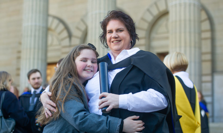 Lily Foy (9) congratulates her mum, Michelle Currie who celebrastes a Post Grad in Education.