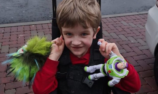 Kade Logan with his previous wheelchair - the chair that was taken is similar, but had a headrest.