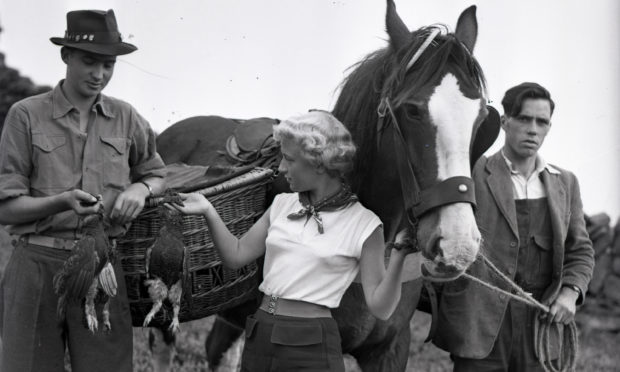 Prince Carlos with beater Fiona Cowans, Aberfeldy, in 1955