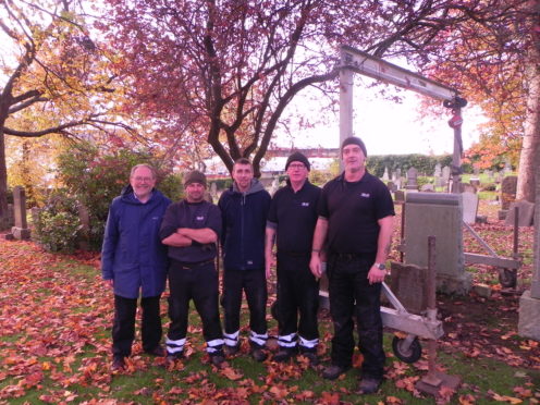 Councillor Tim Brett with members of the team reviewing Fife's head stones.