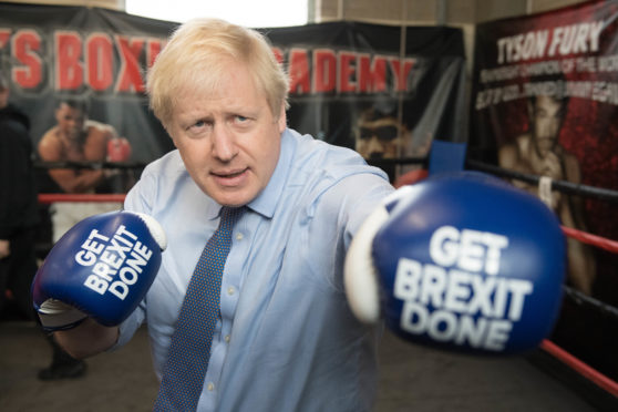 Prime Minister Boris Johnson during a visit to Jimmy Egan's Boxing Academy at Wythenshawe, while on the campaign trail.